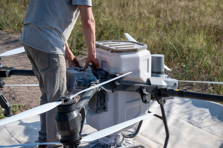 Operator replacing battery of agricultural drone.の写真素材