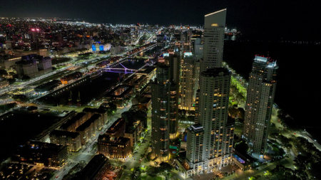 Urban landscape of Puerto Madero at sunset, with the city of Buenos Aires in the background. Aerial night view.の写真素材