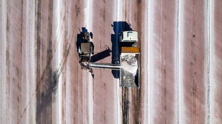 Aerial view of Machinery being employed at the mining industry, tractors and trucks being employed at a surface mine of extraction of salt.の写真素材