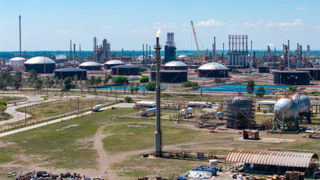 Image of a refinery flare with a controlled flame burning off excess natural gas and petrochemical...