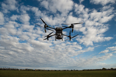 Agricultural drone spreading fertilizer on a newly planted field in Argentina. Smart farm. Unmanned...