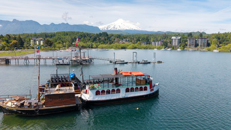 Aerial view of the port of the city of PucÃ³n, with the imposing Villarrica volcano in the background.の写真素材