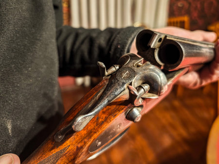 Close-up of weathered wood and rusty metal on an old collectible shotgun.