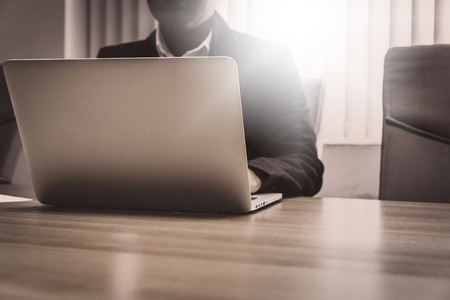 Close up of businessman working in his office with doccument and laptop in business conceptの写真素材