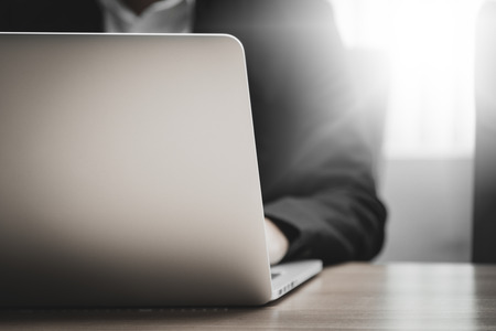 Close up of businessman working in his office with doccument and laptop in business conceptの写真素材