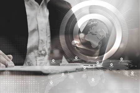 double exposure of businessman working with laptop,smartphone,laptop and row of coins with diagram and digital interface in finance and business conceptの写真素材