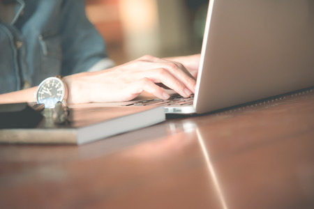 Business women work with  laptop,pen and notebook on the wooden tableの写真素材