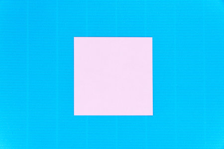 Blue paper background with small paper note