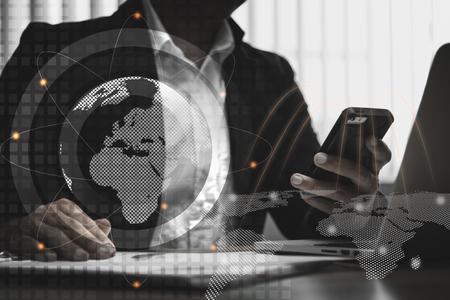 double exposure of businessman working with  row of coins,laptop,smart phone and calculator with diagram and digital interface in finance and business conceptの写真素材