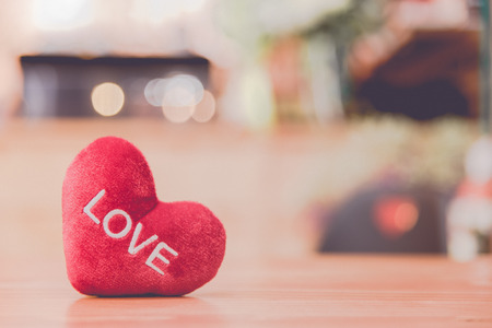 Heart with love word is on wooden table with love and valentine conceptの写真素材