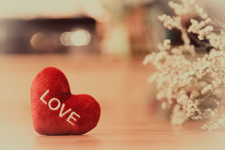 Heart with love word is on wooden table with love and valentine conceptの写真素材