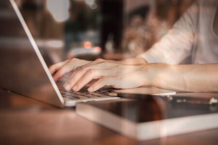 Business women work with  laptop,pen and notebook on the wooden table in business and working conceptの写真素材