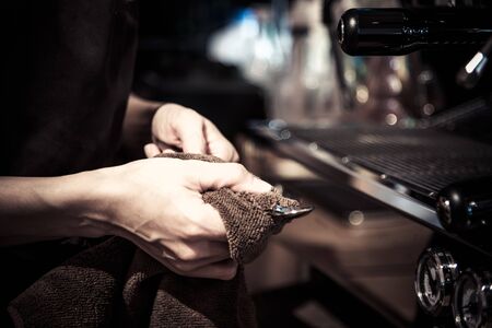 Barista clean a coffee spoon prepare  in cafeの写真素材