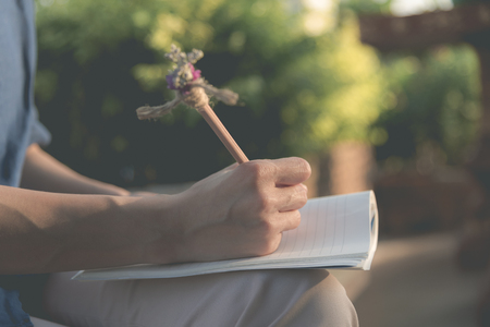 Close up of  people hand  writing on notebookの写真素材