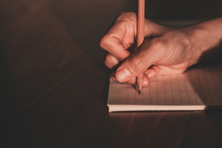 Close up of  people hand  writing on notebookの写真素材