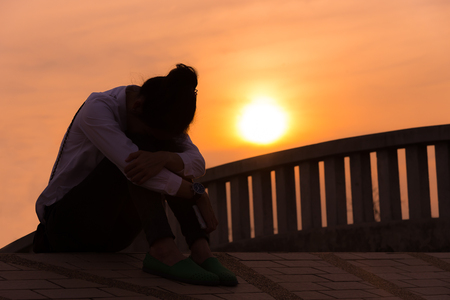 Women on sad concept in the sunsetの写真素材