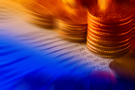 row of coins  and account book on the table in banking and finance conceptの写真素材