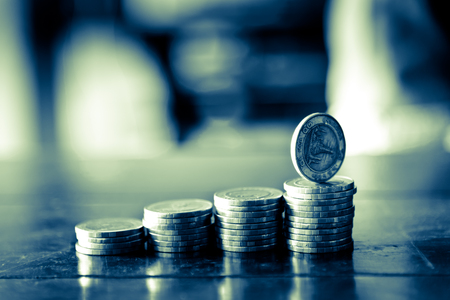 row of coins in banking and finance conceptの写真素材