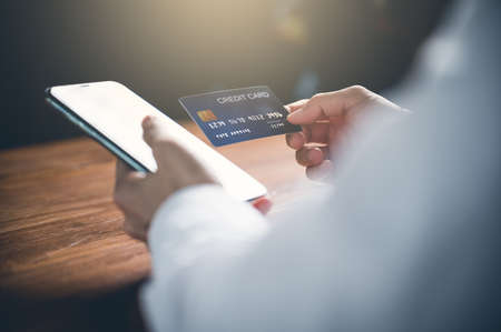 Close up of woman's hand using cellphone or mobile for shopping online or payment with credit card.Shopping online concept.の写真素材