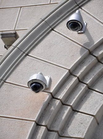 Two hi-speed cameras CCTV on the stone wallの写真素材