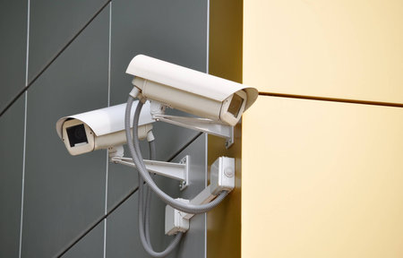 Two CCTV cameras on the cone of the morden building