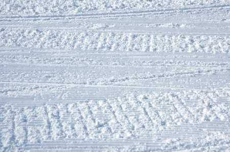 Traces of a snowmobile on the ski slopesの写真素材