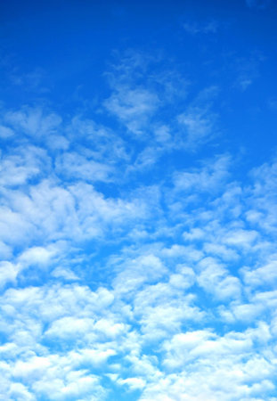 Vertical background with clouds in blue sky