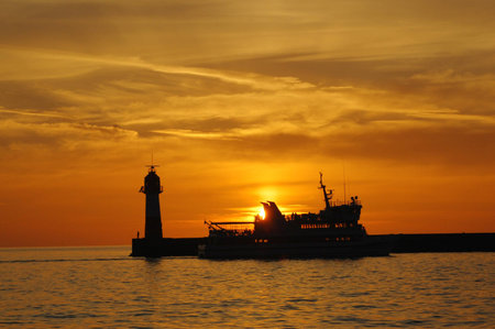 Catamaran goes to port on sinset, Sochi, Russiaの写真素材