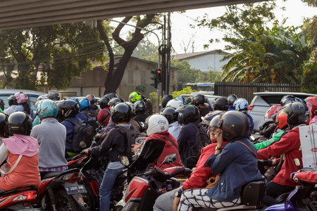 Jakarta / Indonesia - June 09 2018: Crush of scooters waiting for the traffic lights to change color...