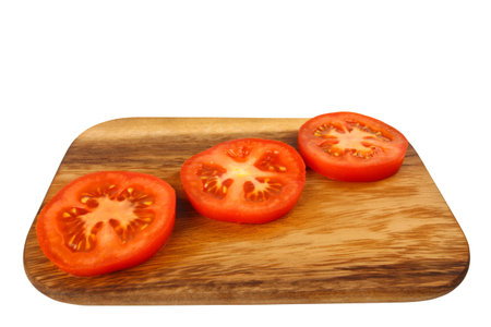 Cutting board with tomato slices isolated on white