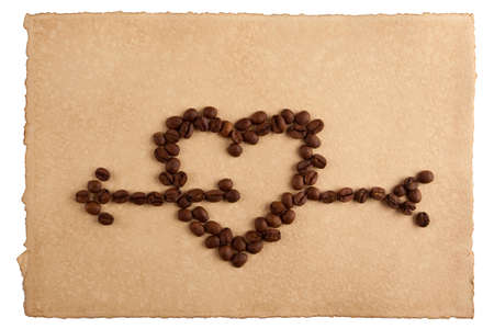 Heart symbol made from coffee crops on hand-made paper and isolated on white  Place for text の写真素材