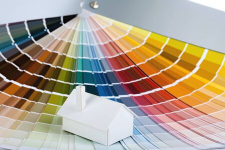 Small simple white model house on a color palette  の写真素材