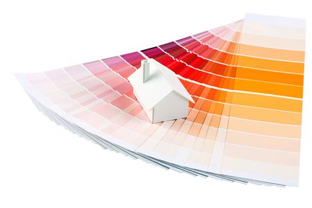 Small simple white model house on a color palette with different colors of orange spectrum.の写真素材