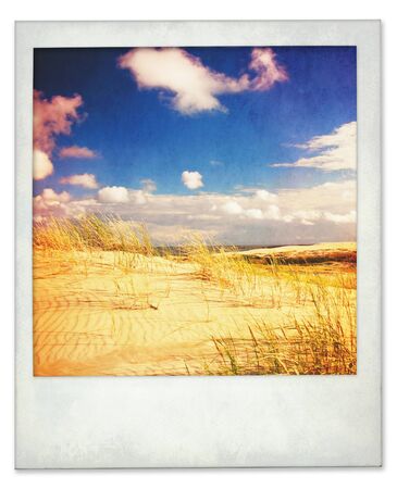Aged and a little dirty instant photo of dunes and sky with light leaksの写真素材