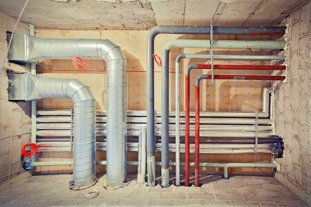 Pipe system of air-conditioning, water and gas shot in a new built unfinished building.の写真素材