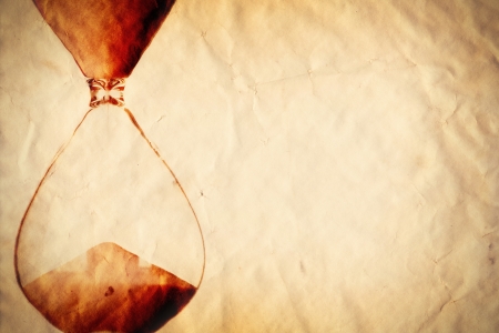 Time concept, vintage sand clock on paper backgroundの写真素材