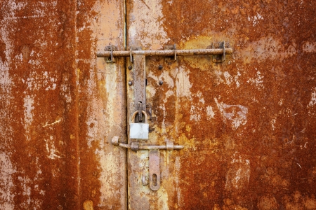 Rusty metal wall and door with lockの写真素材