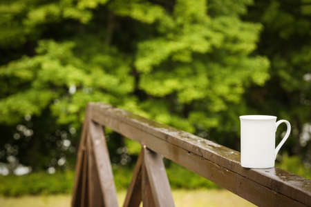 Cup of coffee on a rainy day in natureの写真素材