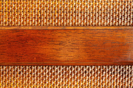 Wooden (bamboo) mesh texture with a plank of wood for copyspace, design detailの写真素材