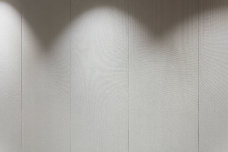 Gray textile covered wall with light spotlightsの写真素材