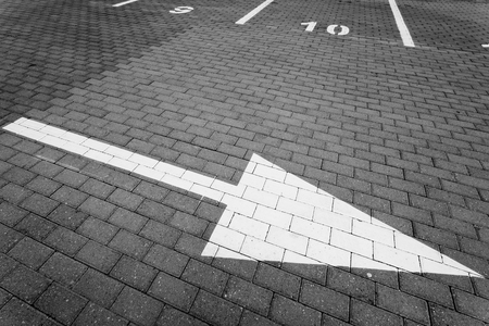 Driving direction arrow in the parking lotの写真素材