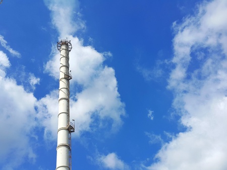 Blue sky with white cloud and stack tower backgroundの写真素材