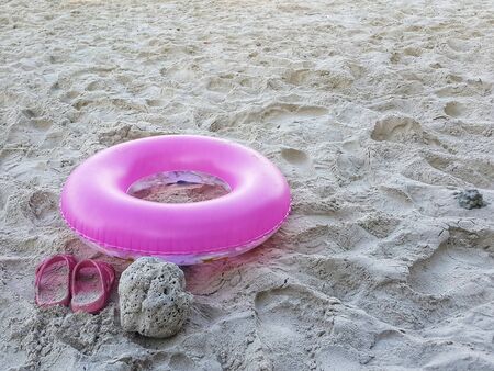 Pink life ring on sand beach,family vacationsの写真素材