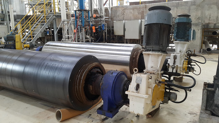 electrical parts and Mechanical parts on Big gear and drum rolls on white floorの写真素材