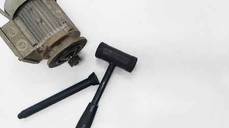 Electric motor with pinion gear and black hammer for Repair and Overhaul motor gear on white isolated backgroundの写真素材