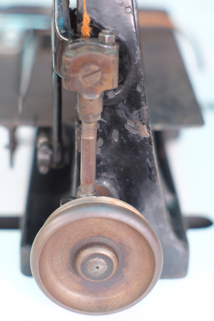 Close-up part of an old sewing machine and detail on adjust  thread , free-wheeling balance wheelの写真素材