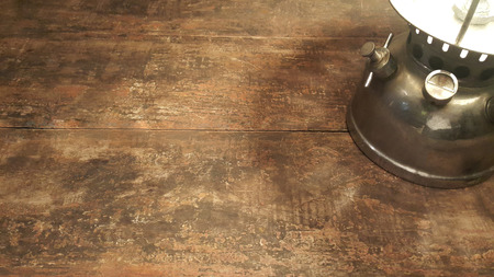 Lighting of the kerosene lantern on wooden table , Vintage kerosene lantern backgroundの写真素材