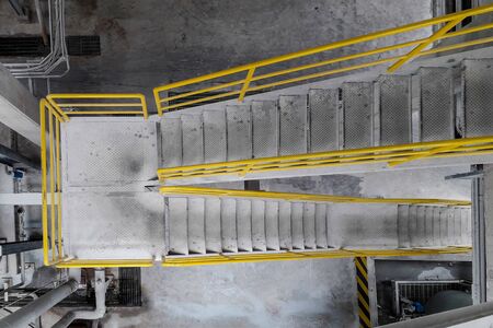 Walk way with yellow handrail inside factoryの写真素材