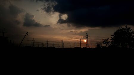 The sunset and High voltage electric pole silhouetteの写真素材