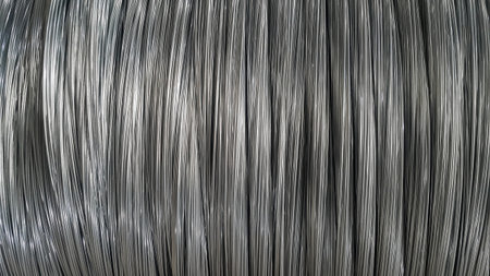 Small silver wires arranged vertically, abstract background
